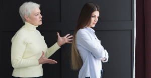 woman with her back to older woman.  Older woman is trying to explain something to her