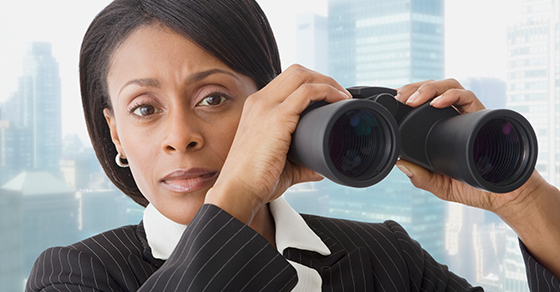 business woman holding binoculars