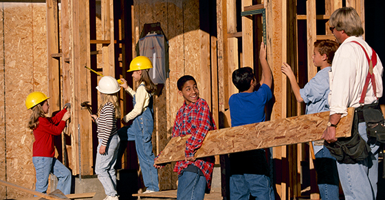 Group of volunteers building house