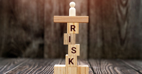 letter blocks stacked upright to spell risk