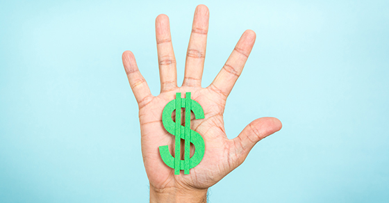 blue background with hand showing all 5 fingers spread out and a green dollar sign on the palm