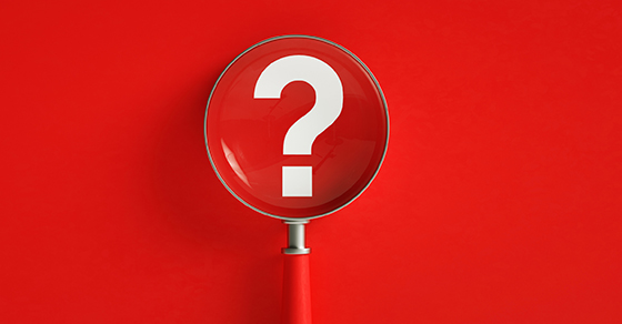Magnifier And Question Mark On Red Background