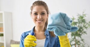 cleaning woman wearing cleaning gloves with rag and spray bottle 