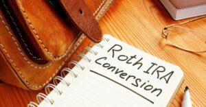 notebook on table open to page with heading Roth IRA conversion
