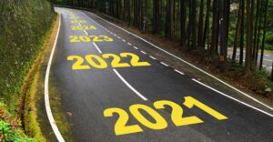 Road with years written in yellow down center.  As you drive down the road, the years increase starting at 2021 and going up from there