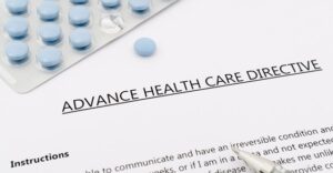 close up of printed advance health care directive with bubble pack of pills above it