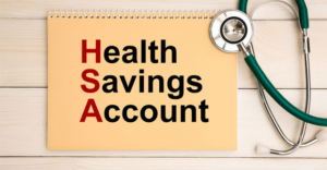 notebook with stethoscope next to it and words Health Savings Account on cover