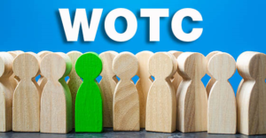 blue background with wooden people shaped figures. All natural wood except one is painted bright green with letters WOTC above them representing work opportunity tax credit