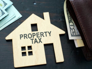 Property tax sign on a house model.