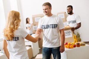Thank you for joining. Inspired committed vibrant volunteer welcoming other volunteers who want to make the world a better place while working in a food donations area