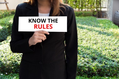 KNOW THE RULES - Businesswoman showing the card