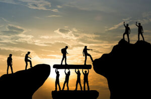 Group of people on peak mountain climbing helping team work , leadership success business concept
