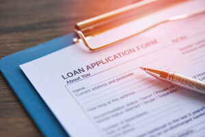 Loan application form with pen on paper / financial loan negotiation for lender and borrower, application to borrow 