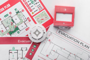 Evacuation plans, smoke detector and manual call point on white background, disaster plan