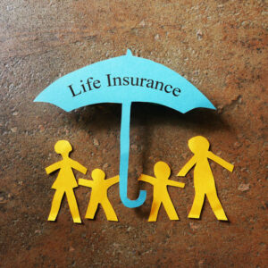 a paper cut out family under an umbrella that has the words life insurance written on it.