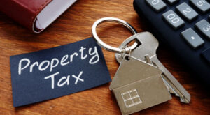 property taxes tag attached to keychain with house emblem on chain