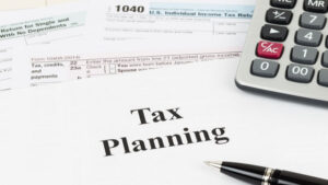 Tax planning with calculator taxation concept
