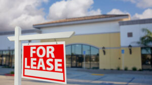 Vacant commercial real estate or Retail Building with For Lease Real Estate Sign