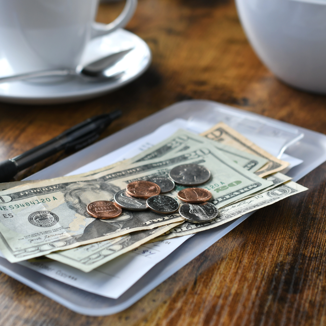 cash and change tips left on table of restaurant