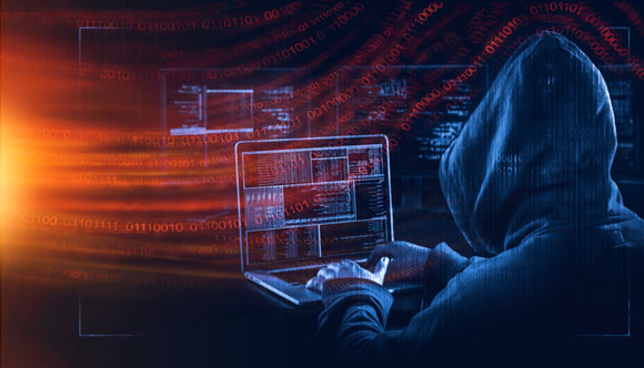 hooded hacker at laptop with data and multiple screens flowing around in a solar wind concept showing cyberattacks in process