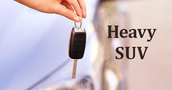 hand holding key with words heavy suv
