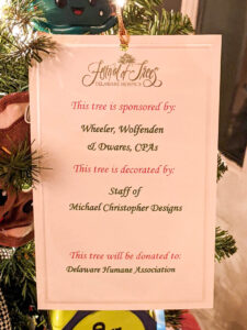 Festival of Trees sponsor tag listing Wheeler Wolfenden & Dwares as sponsors, decorated by Michael Christopher Designs, and donated to Delaware Humane Association