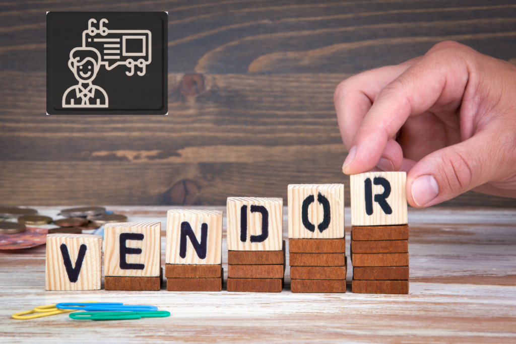 Wooden letters on the office desk. Letters spell Vendor and are stacked to increase in height from left to right. A hand is placing the last letter on the stack of blocks. In the upper left corner is a contact card icon with a black background, indicating a vendor's information.